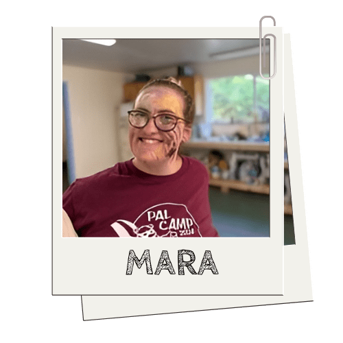 Person smiling in a room, wearing a maroon 'PAL Camp 2021' shirt; photo labeled 'MARA'.