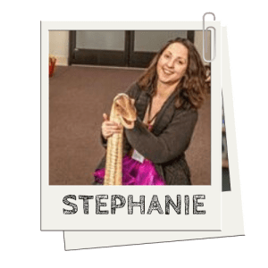 Person smiling, holding a large snake indoors, label 'STEPHANIE' below image.